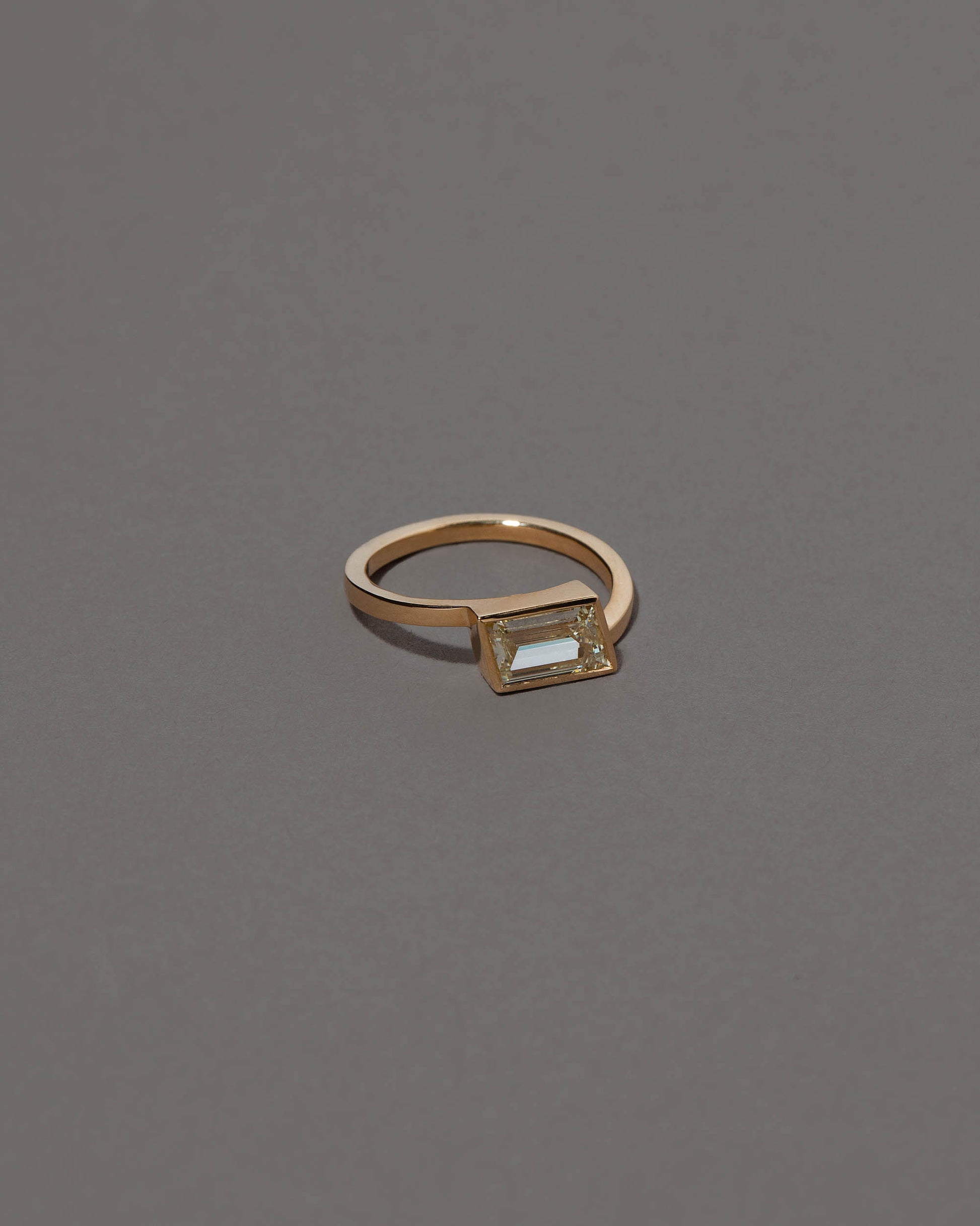 View from the side of the Jocundity Ring on grey color background.