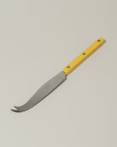 Sabre Paris Yellow Cheese Knife on light color background.