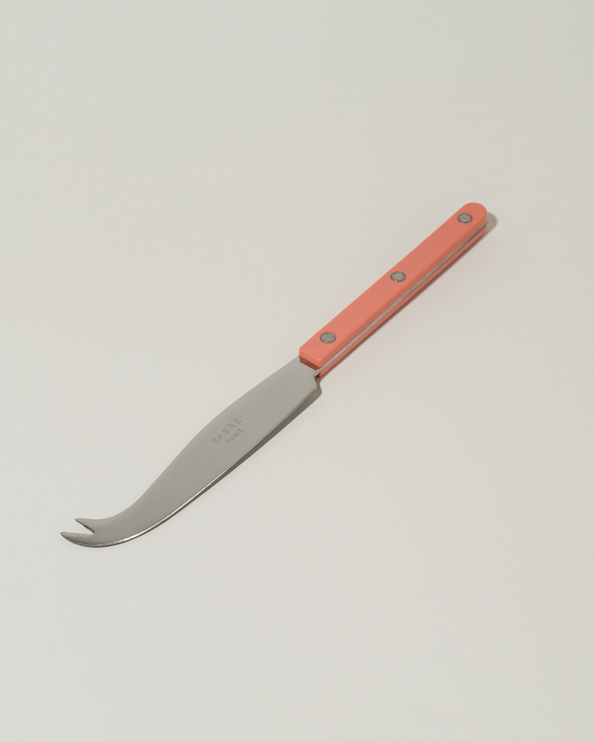 Sabre Paris Nude Pink Cheese Knife on light color background.