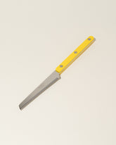 Sabre Paris Yellow Tomato Knife on light color background.