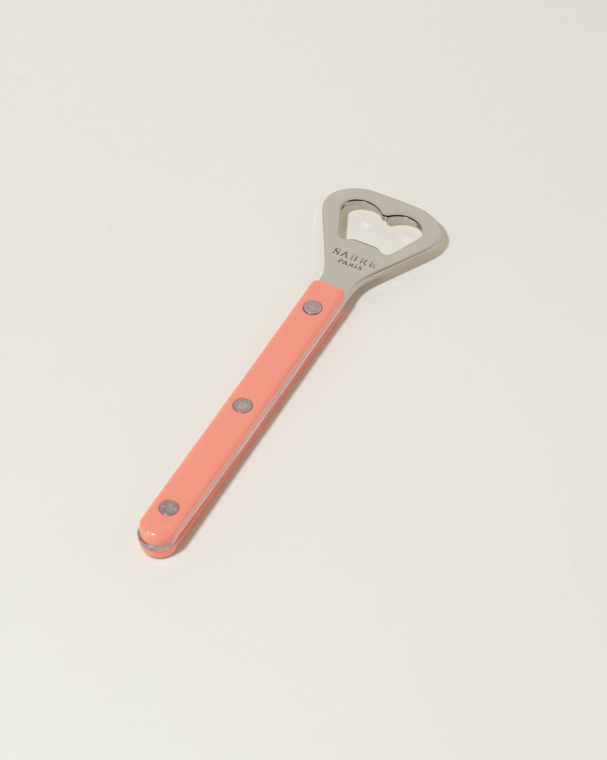 Sabre Paris Nude Pink Bottle Opener on light color background.