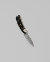 Santa Fe Stoneworks Black Buffalo Turquoise Small Lockback Knife on light color background.