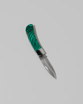 Santa Fe Stoneworks Tru Stone Malachite Small Lockback Knife on light color background.