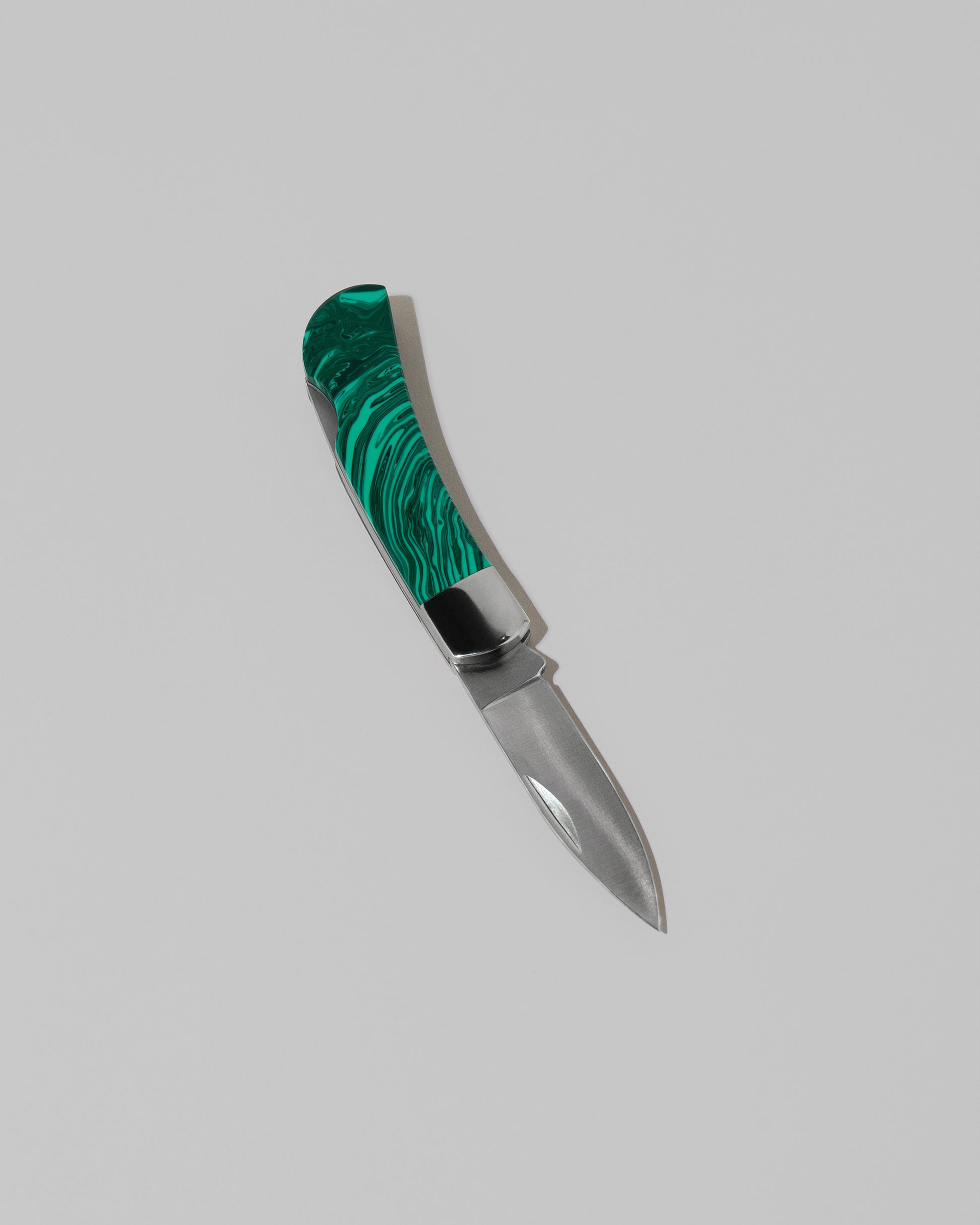 Santa Fe Stoneworks Tru Stone Malachite Small Lockback Knife on light color background.