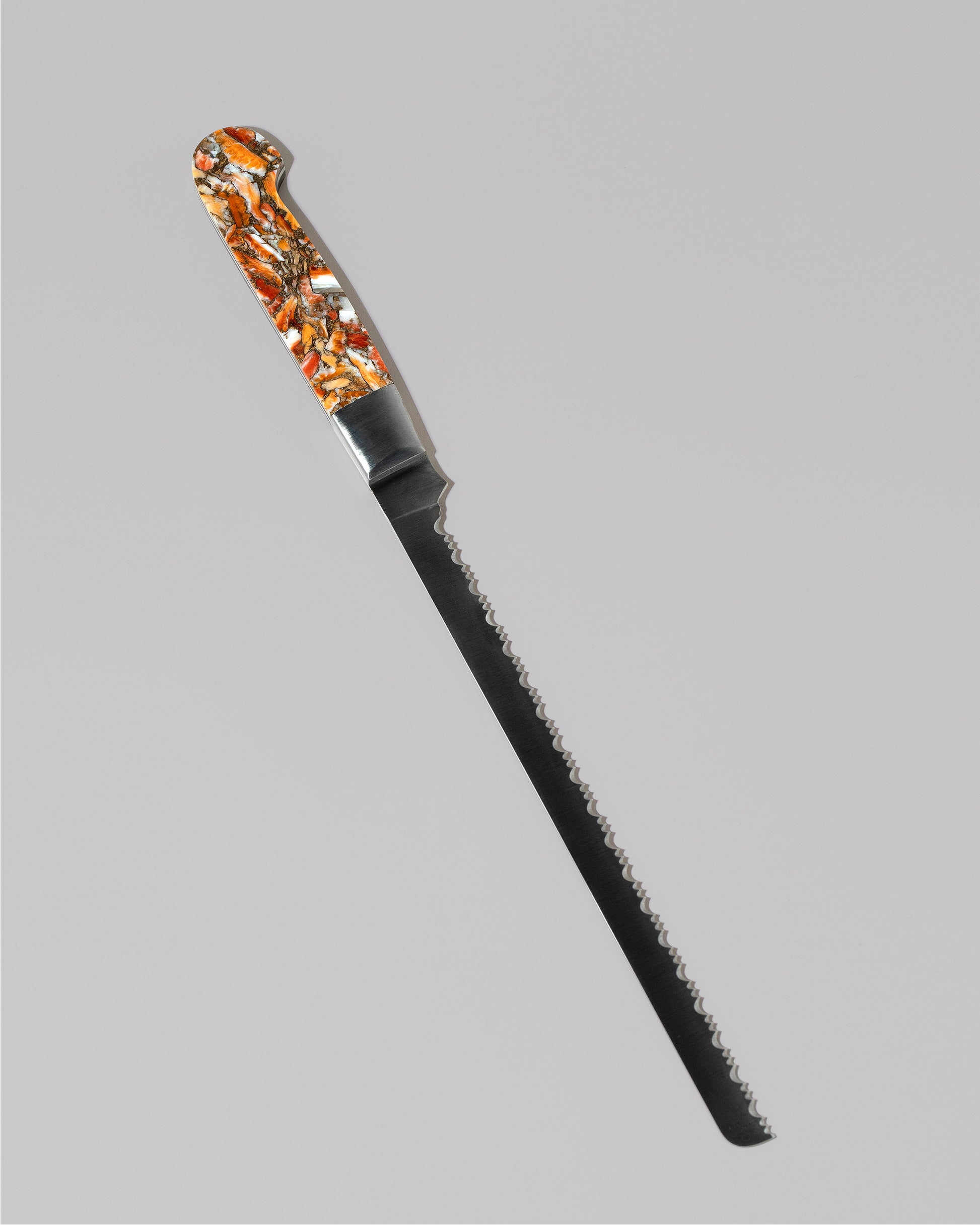 Santa Fe Stoneworks Spiney Oyster Bread Knife on light color background.