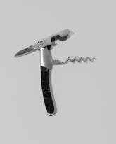 Detail view of the Santa Fe Stoneworks Black Buffalo Turquoise Waiter's Knife on light color background.