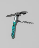 Detail view of the Santa Fe Stoneworks Kingmen Turquoise Waiter's Knife on light color background.