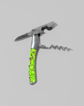 Detail view of the Santa Fe Stoneworks Neon Ranger Waiter's Knife on light color background.