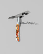 Detail view of the Santa Fe Stoneworks Spiney Oyster Waiter's Knife on light color background.