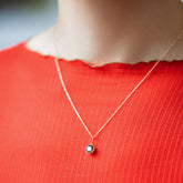 product_details::Bicolor Sapphire Pendant paired with chain on model.