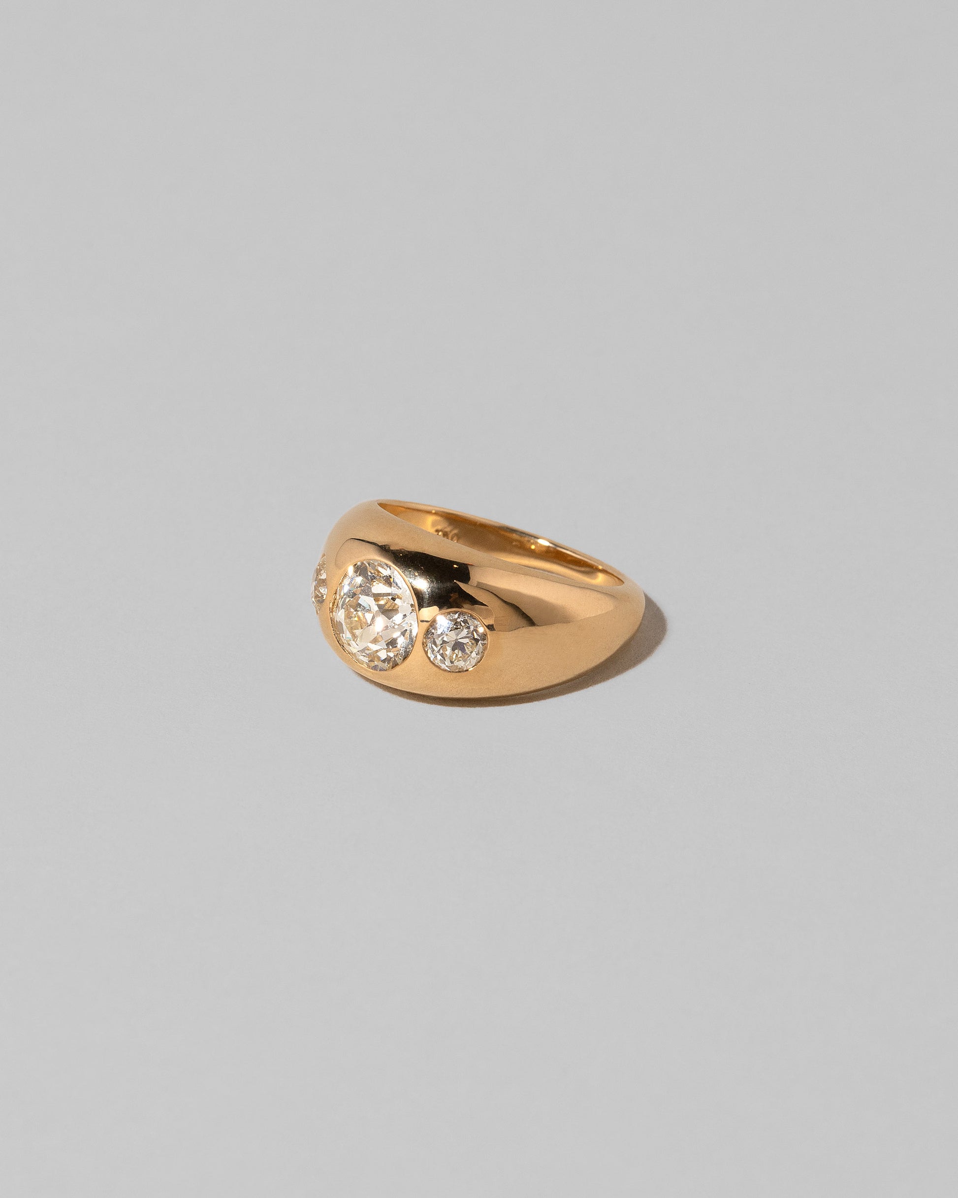 View from the side of the Diamond Saturn Ring on light color background.