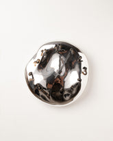 Silje Lindrup Black Hands Two Brown Glass Wall Clock on light color background.