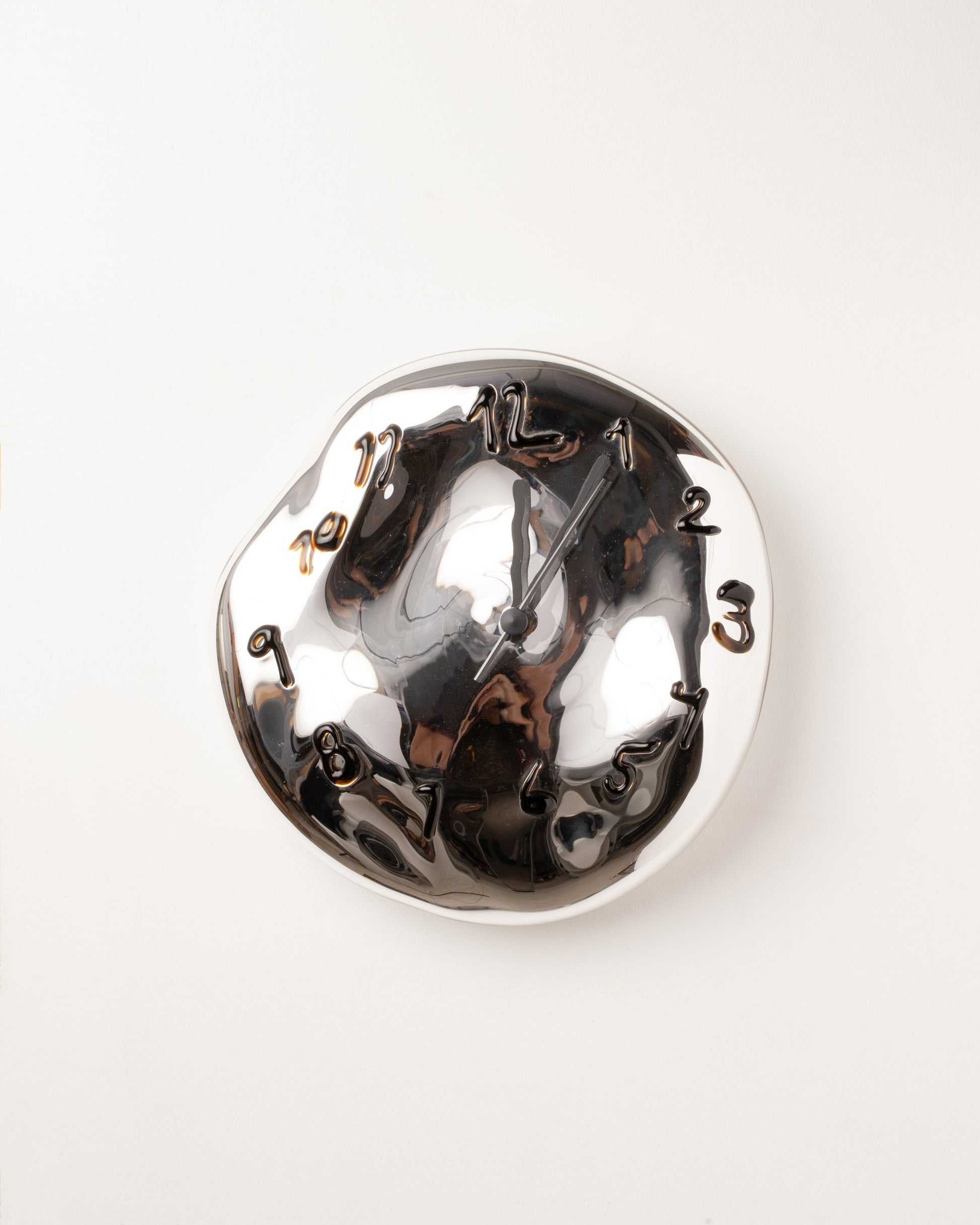 Silje Lindrup Black Hands Two Brown Glass Wall Clock on light color background.