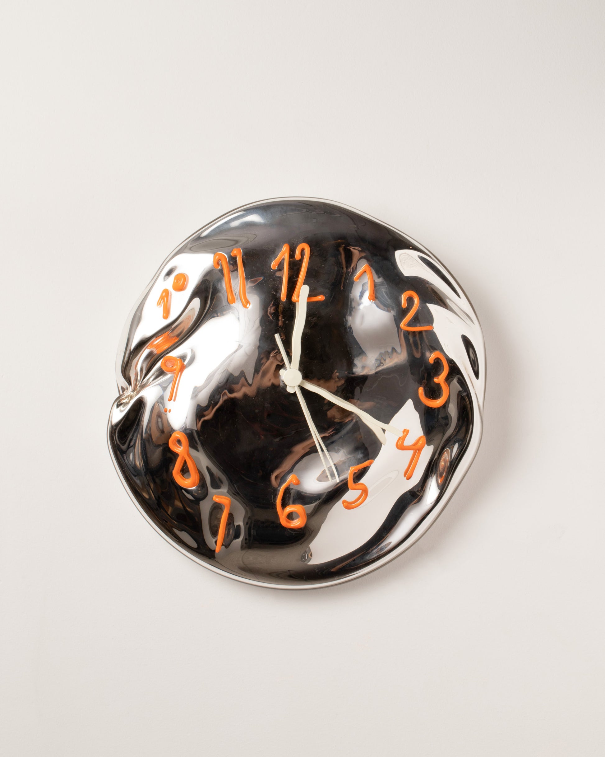 Silje Lindrup White Hands One Orange Glass Wall Clock on light color background.