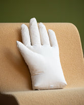 Styled image featuring the Sohn Left Cotton Canvas Soft Sculpture Hand Pillow.