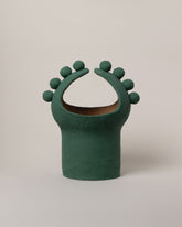 Stephanie Phillips Green Moon Bulb Sculpture on light color background.