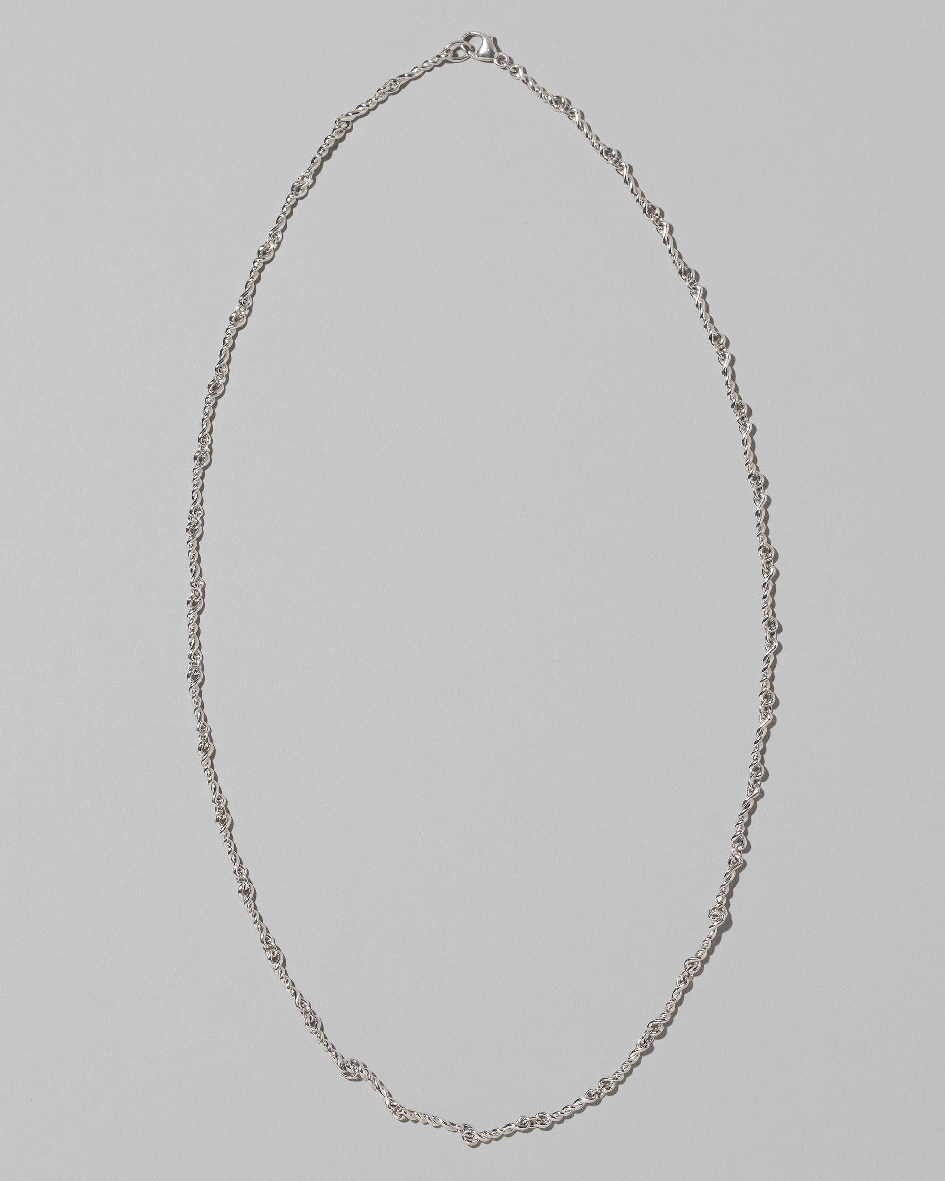 CRZM Sterling Silver Double Helix Chain Necklace on light color background.