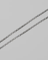 Closeup details of the CRZM 2mm Sterling Silver Short Loop Chain Necklace on light color background.