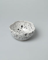 Recreation Center Black Speckle Flower Bowl on light color background.