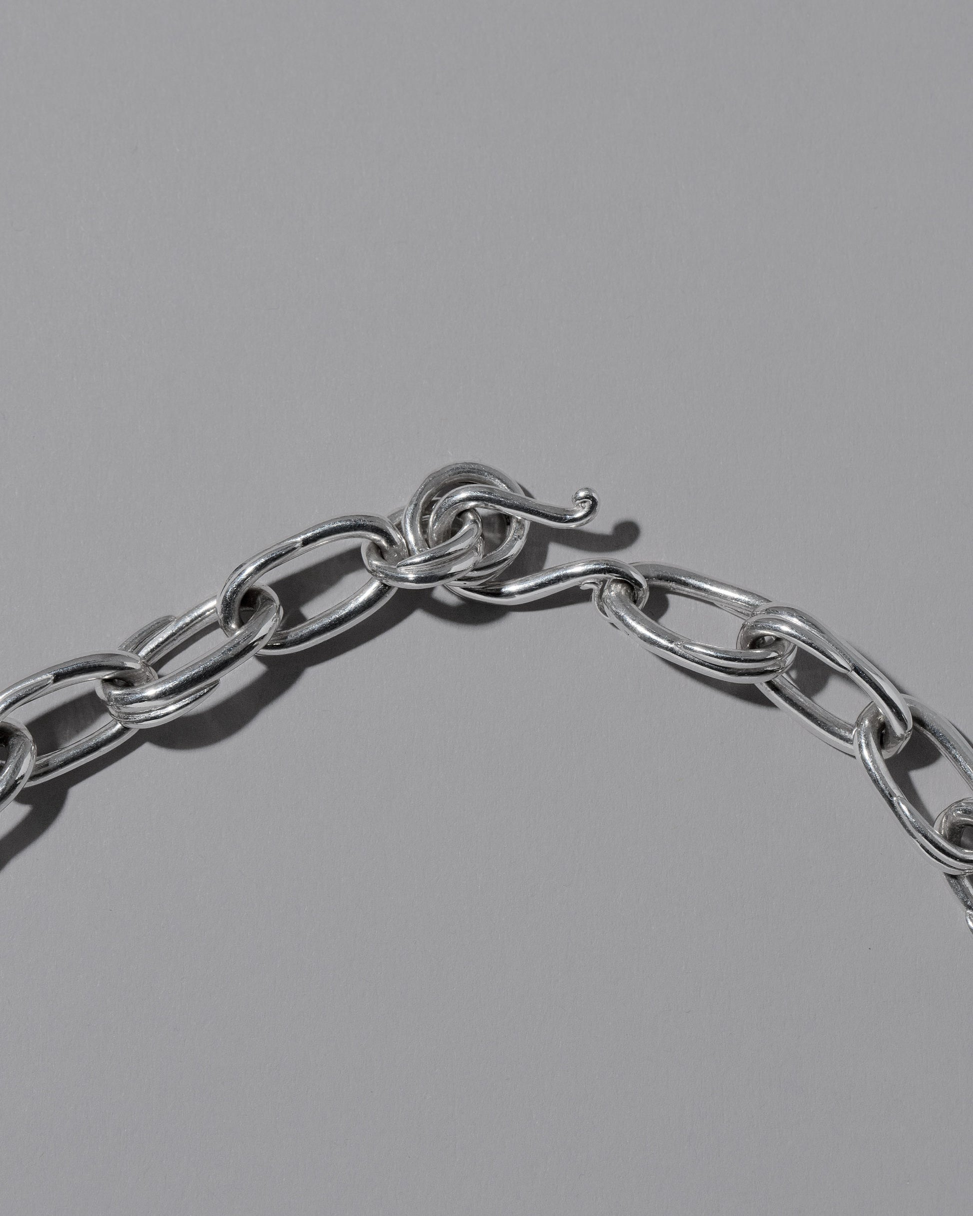 Closeup details of the CRZM Sterling Silver Canyon Bracelet on light color background.