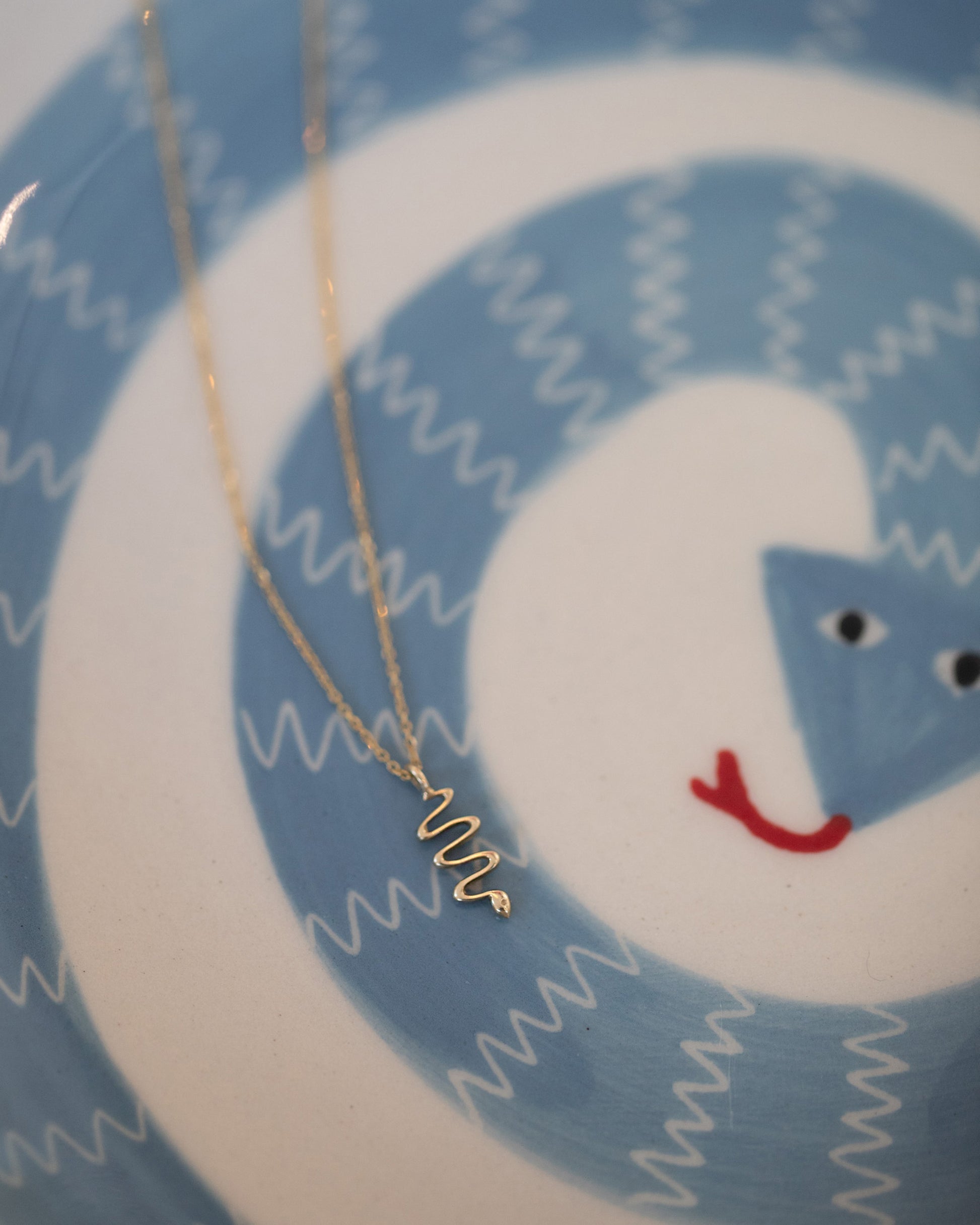 Styled image featuring the Snake Talisman Pendant Necklace.