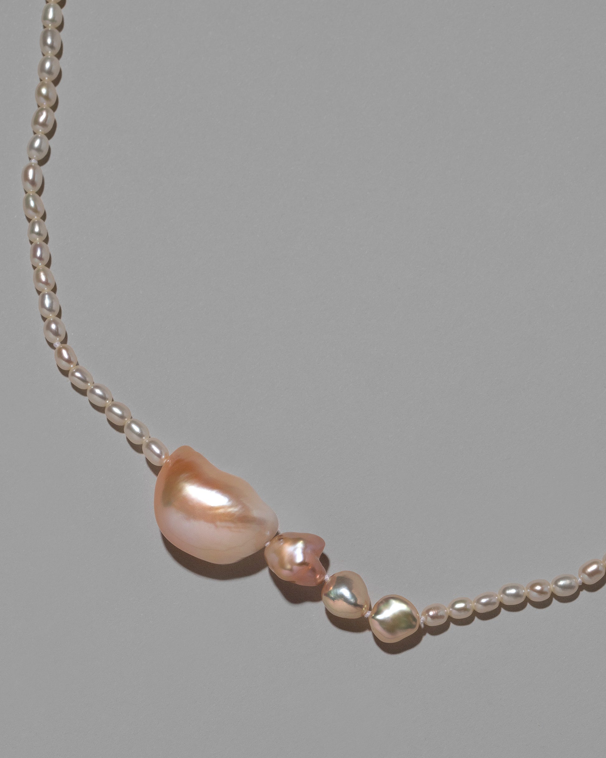 Tethys Pearl Necklace on light color background.