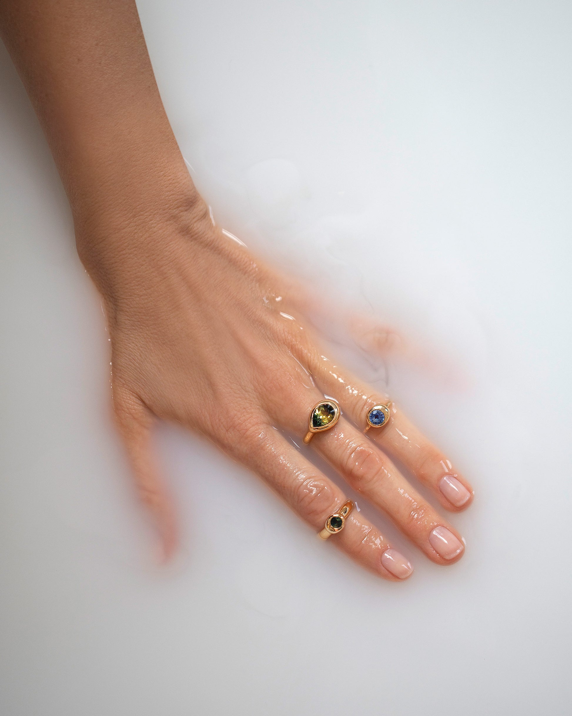 Bicolor Sapphire Grand Align Ring, Blue Sapphire Level Ring, and Green Sapphire Level Ring on model.