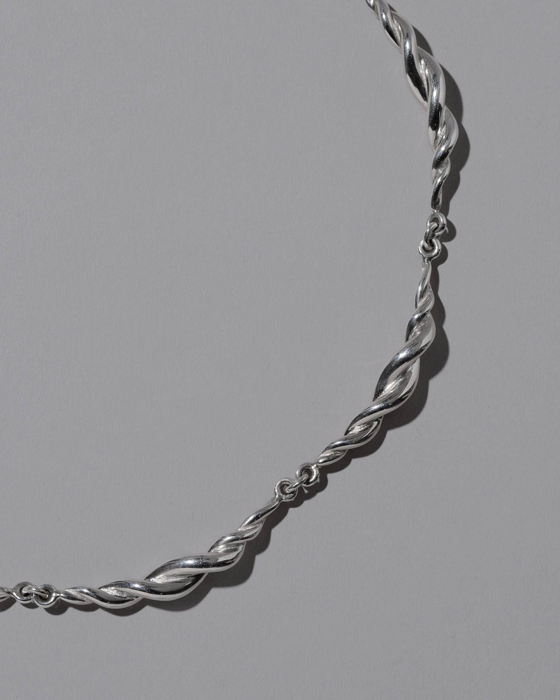 Closeup details of the CRZM Sterling Silver Foothill Bracelet on light color background.