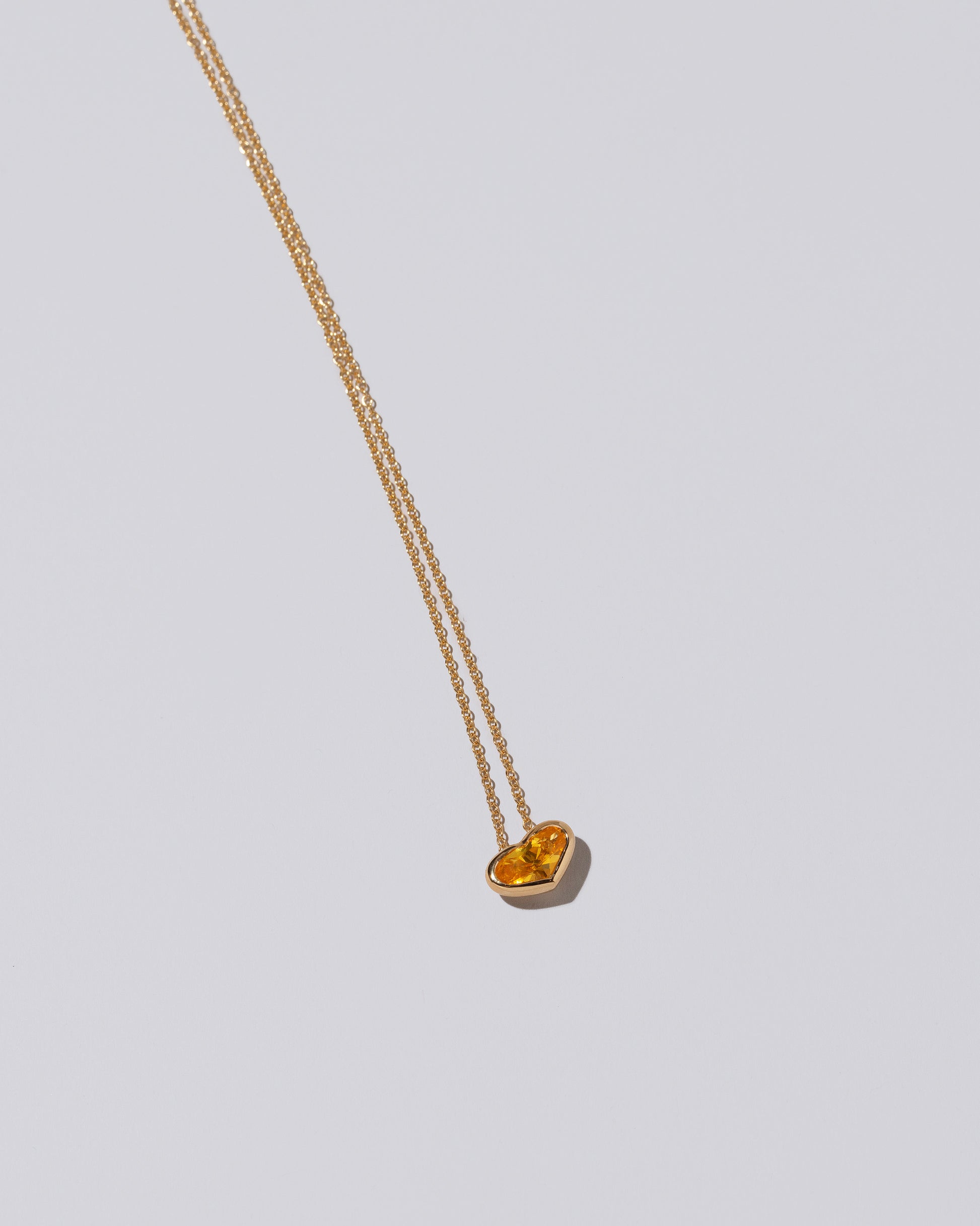 Venus Heart Pendant on light color background.