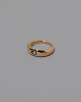 View from the side of the Bicolor Sapphire Venus Ring on grey color background.