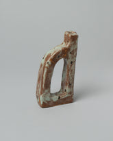 Closeup details of the Willem van Hooff Rust Tiny Core Vessel on light color background.