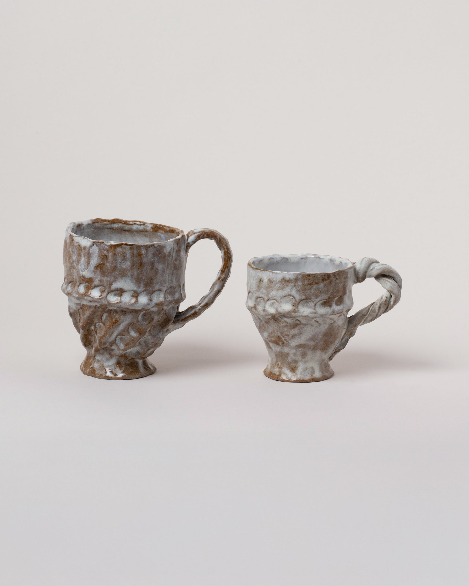 Wonky Ware Ceramics Icy Twist Mug and Icy Short Mug on light color background.