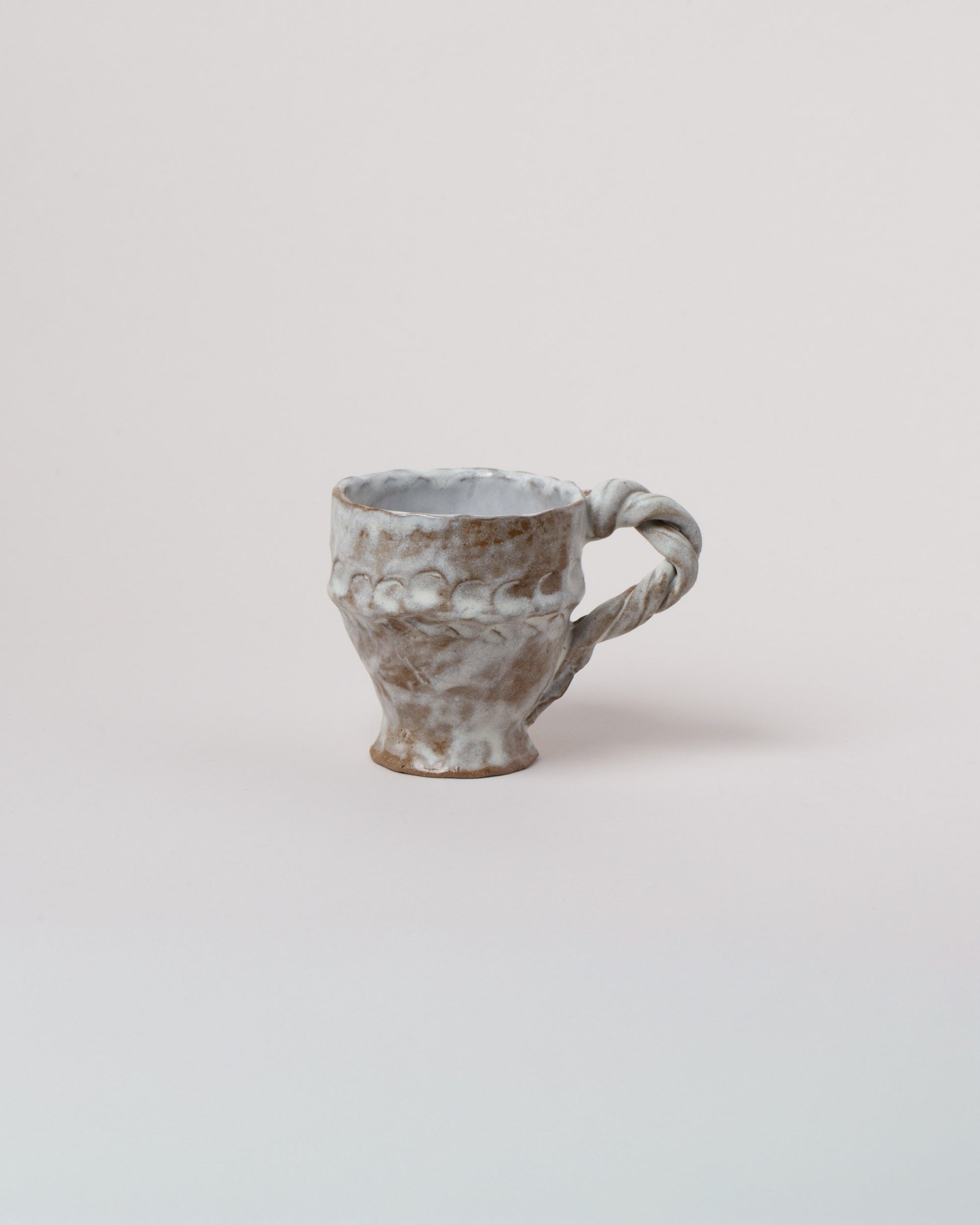 Wonky Ware Ceramics Icy Short Mug on light color background.