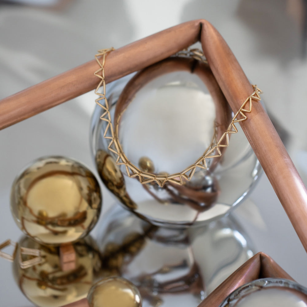 product_details::Styled image featuring the the Flexure Necklace.