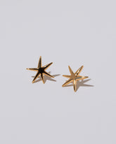 Large Verve Six Point Star Stud Earrings on light color background.