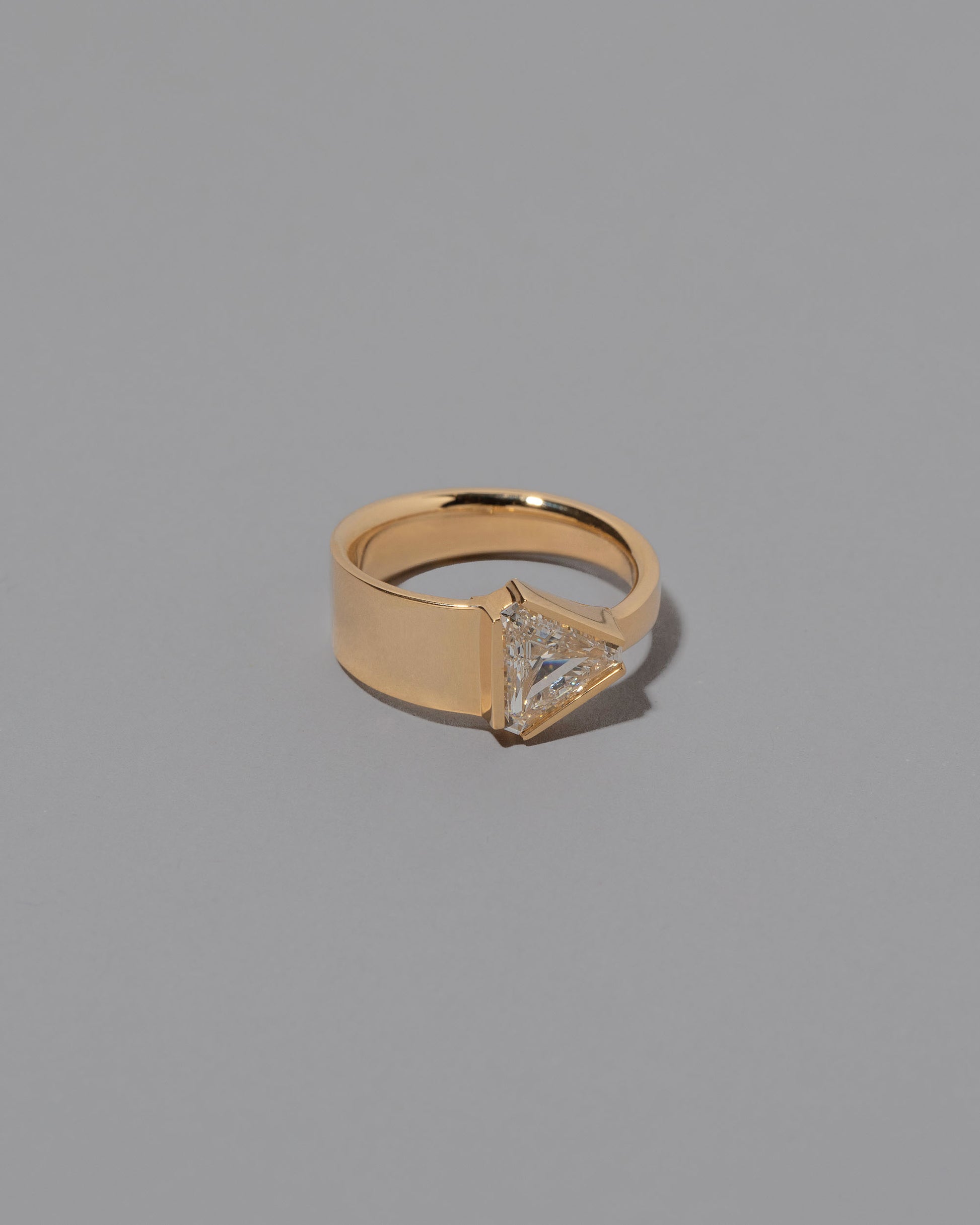 View from the side of the Tuck Ring on grey color background.