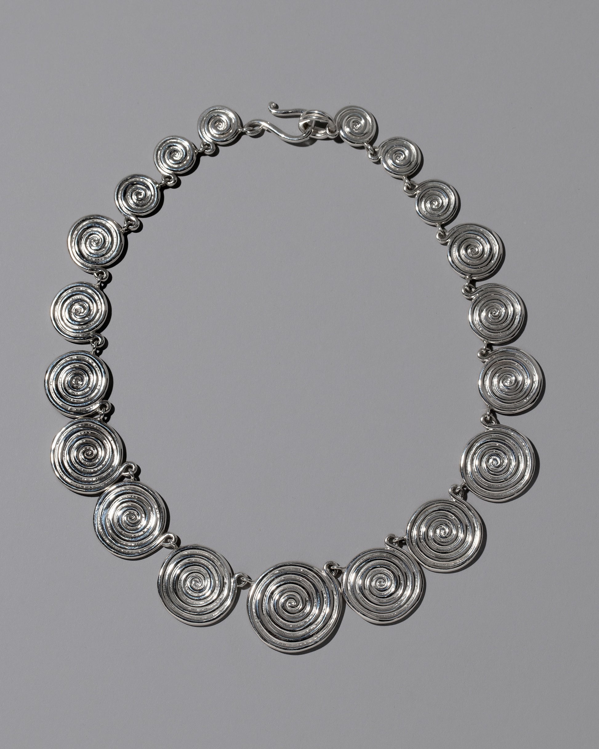 CRZM Sterling Silver Serpentinite Necklace on light color background.