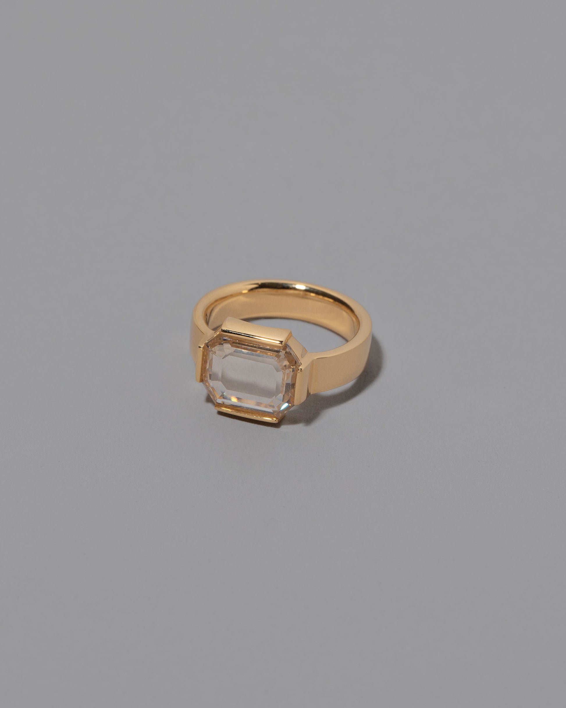 View from the side of the Envelop Ring on grey color background.