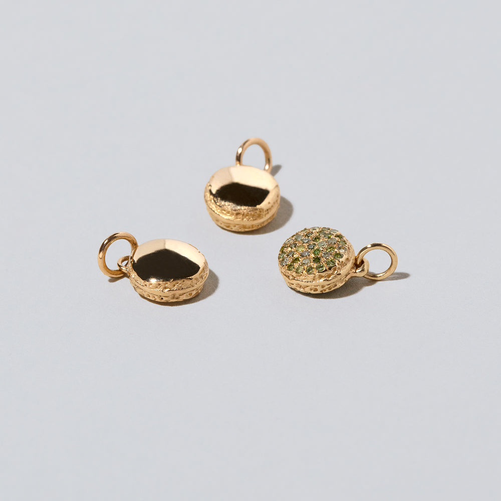 product_details::Mini Macaron Charm - Diamond Pavé Pistachio on light color background.
