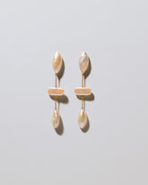 Osprey Pearl Earrings on light color background.