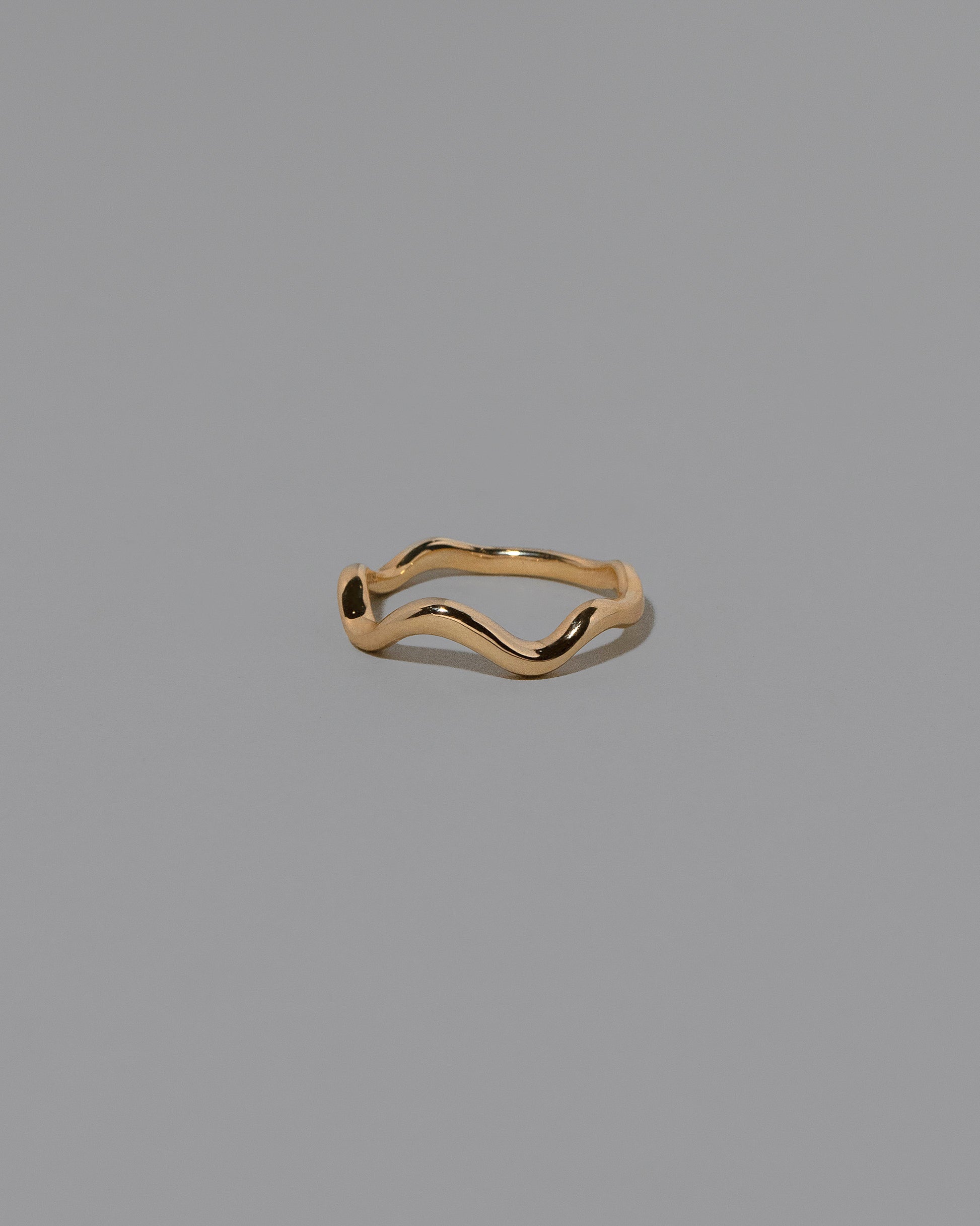 Gold Bump Band on light color background.