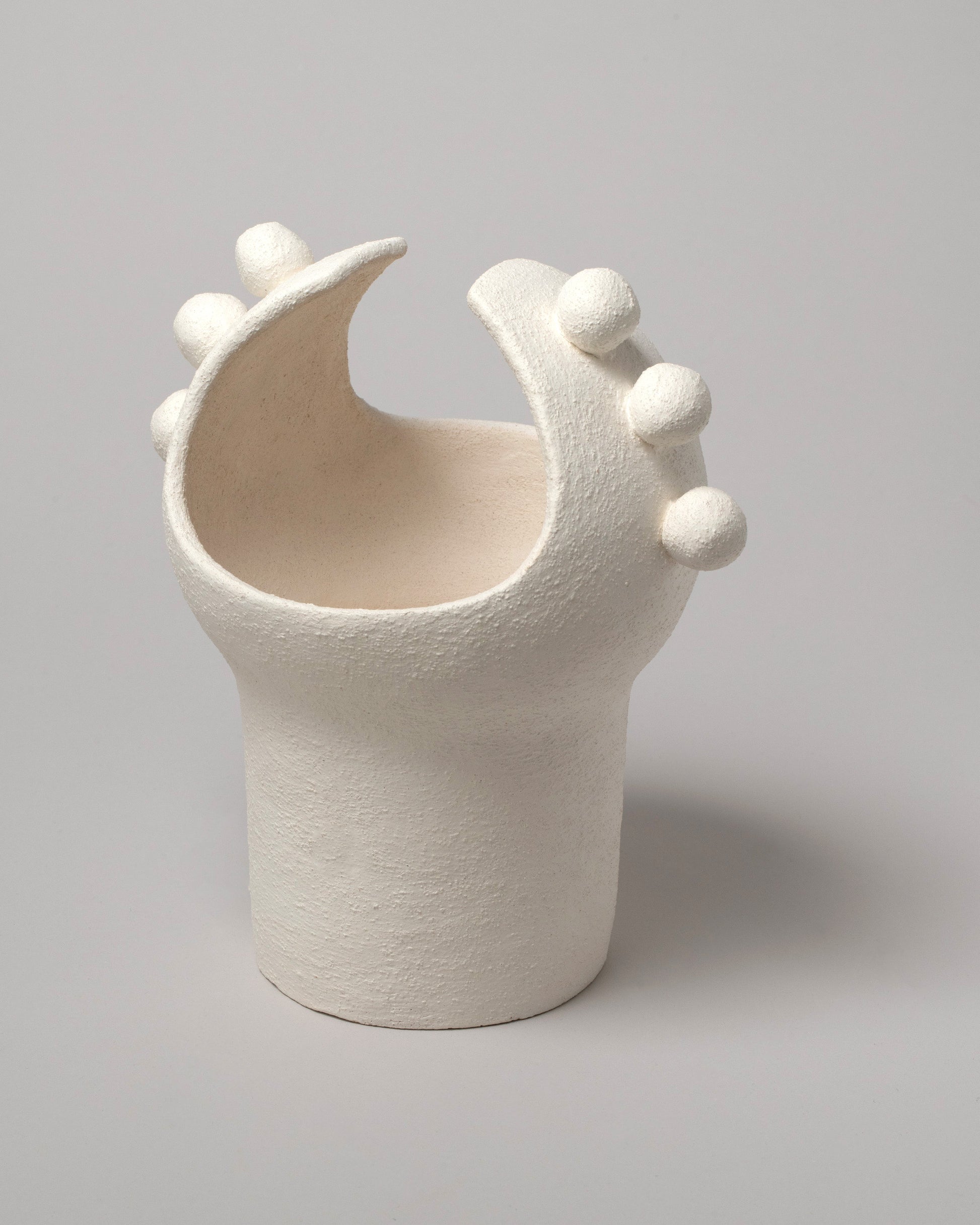 Closeup details of the Stephanie Phillips White Moon Bulb Sculpture on light color background.