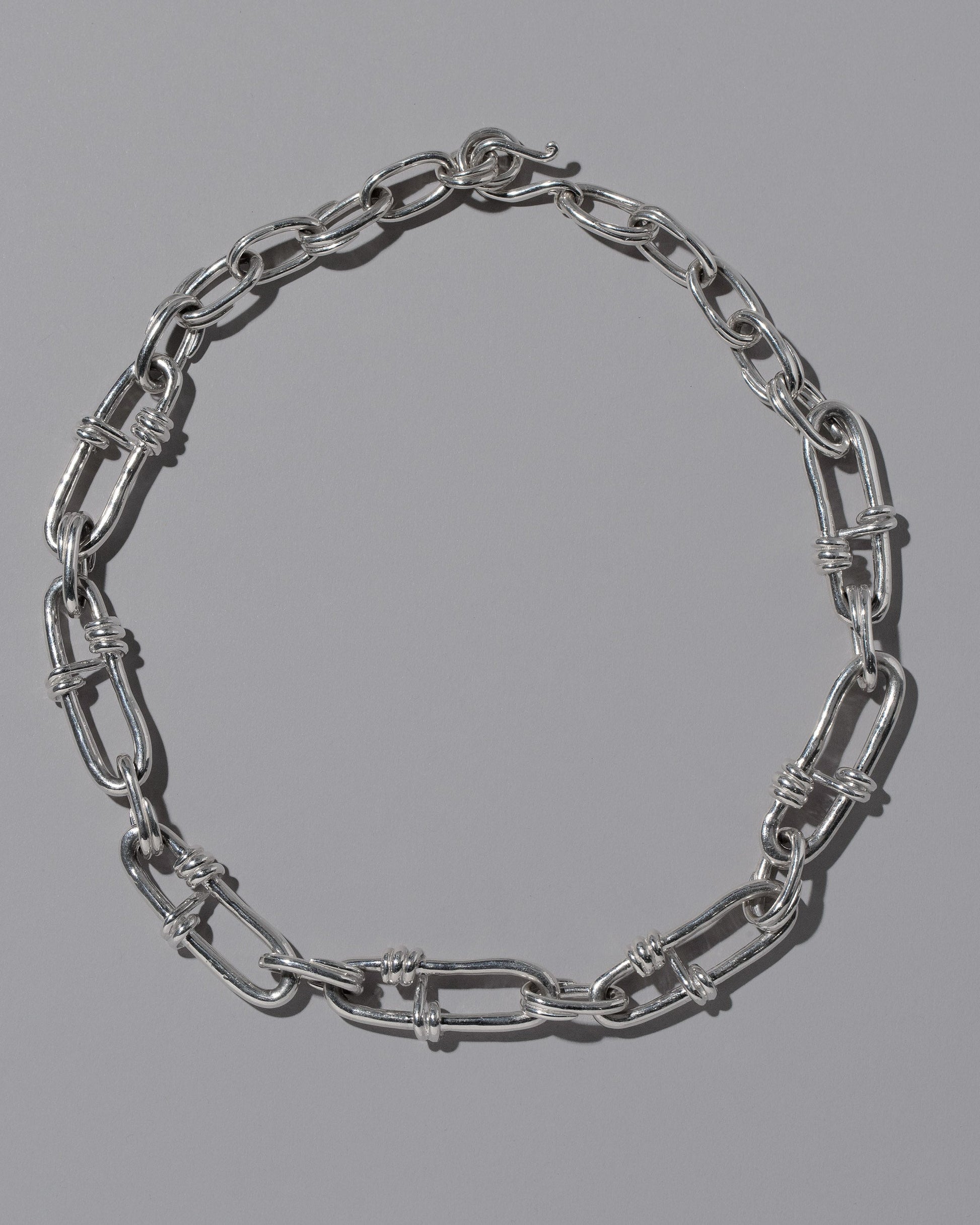 CRZM Sterling Silver Canyon Necklace on light color background.