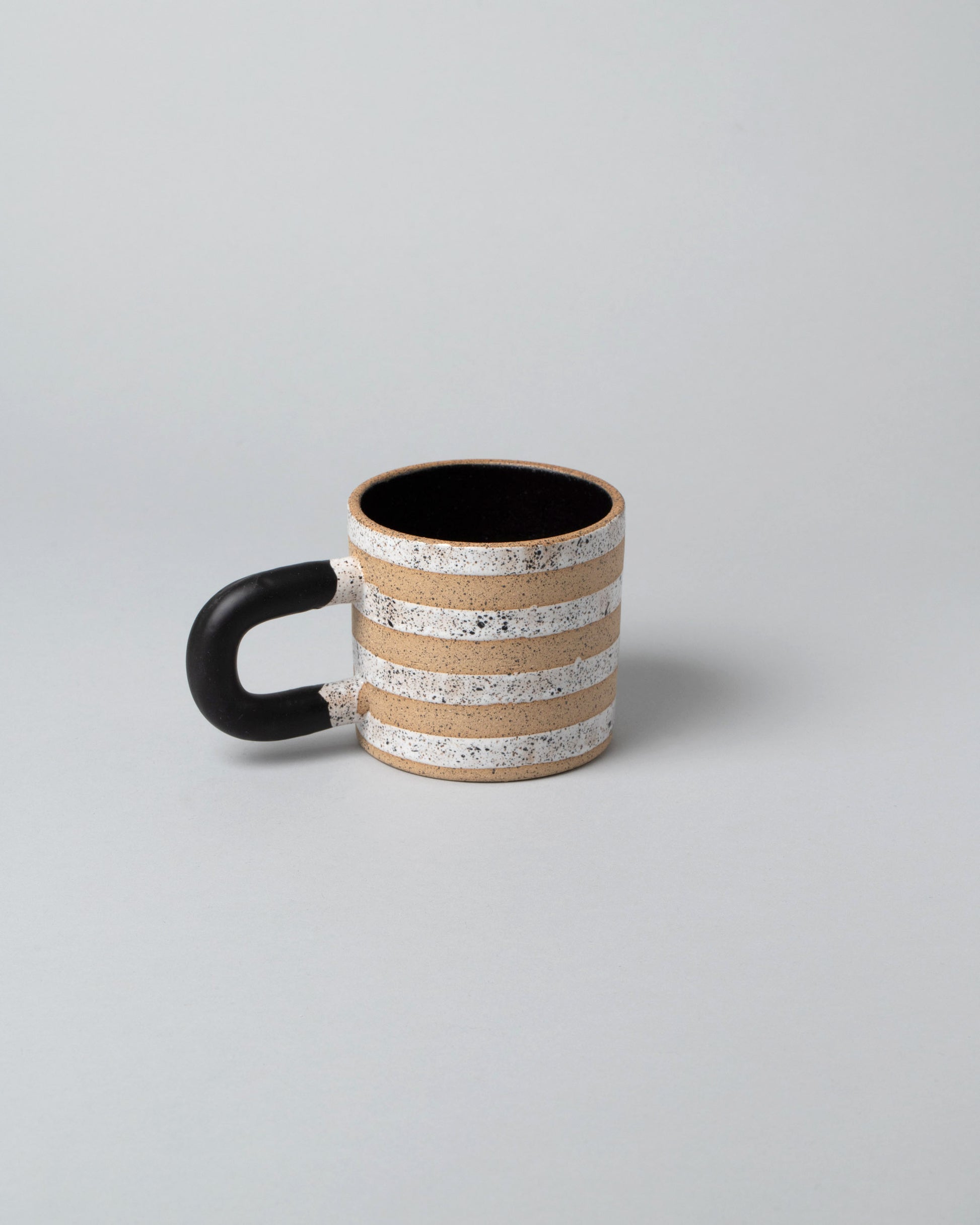 Recreation Center Black Dalmatian Stripe Mug on light color background.