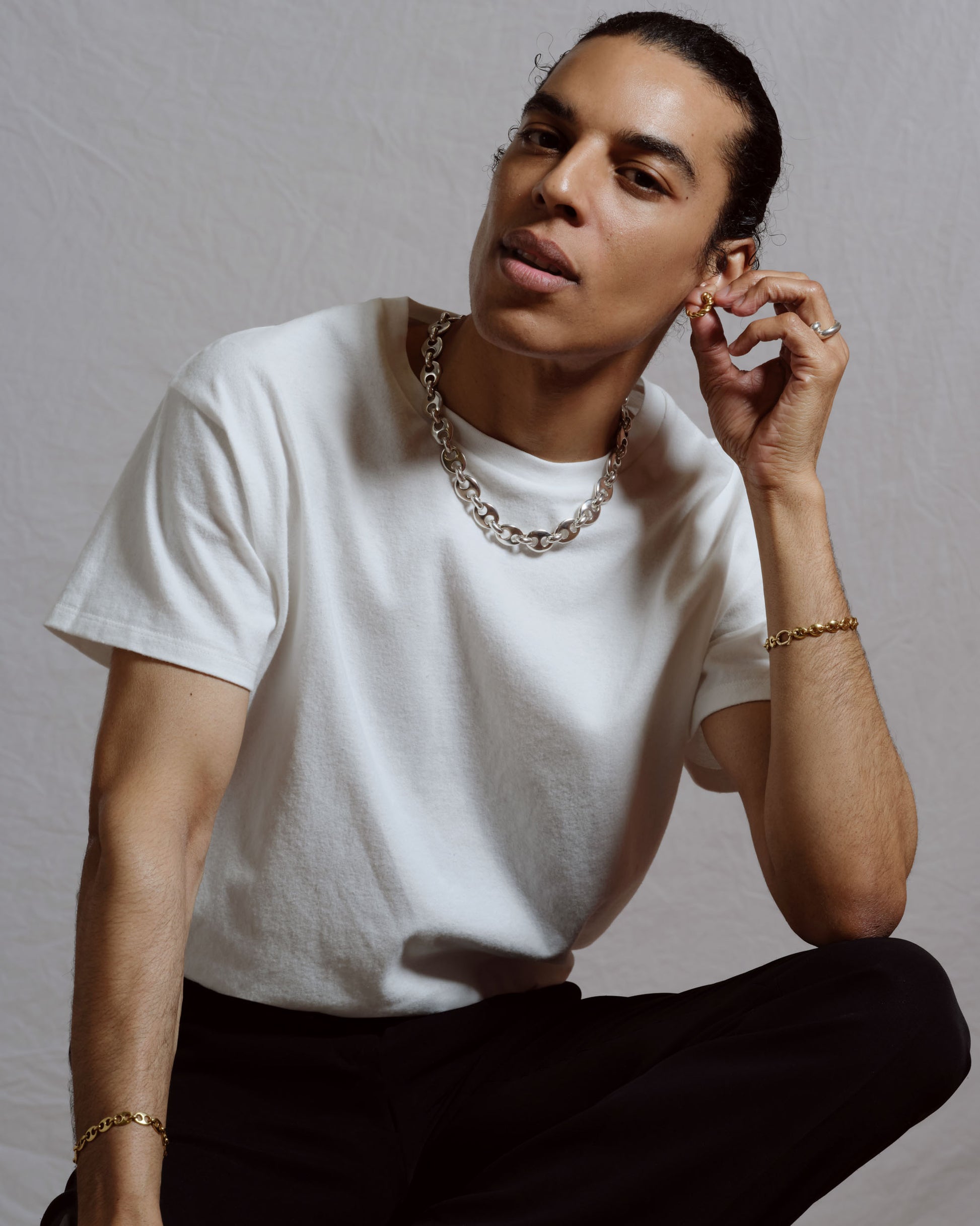 Sterling Silver Yuba Necklace, Solid Gold Yuba Mini Bracelet, Solid Gold Bedrock Mini Bracelet and Sterling Silver Foothill Hoop Earrings on male model.