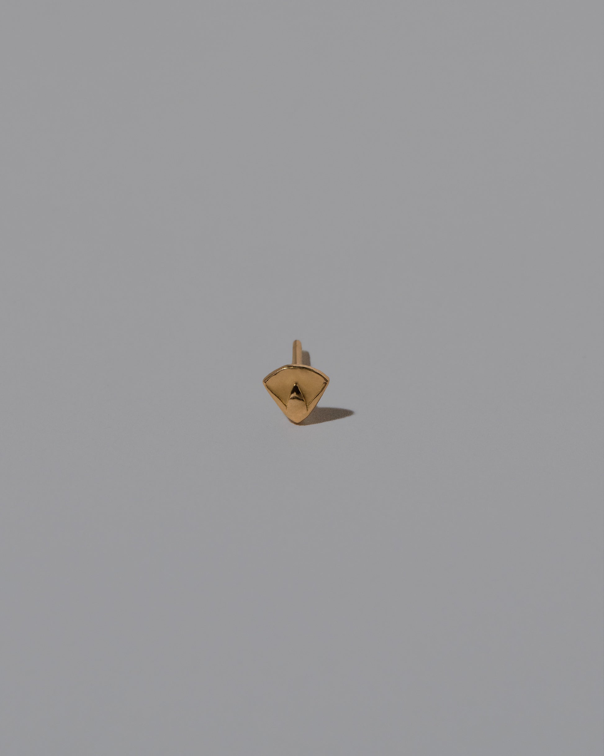 Closeup details of the Lotus Blossom Stud Earring Single on light color background.