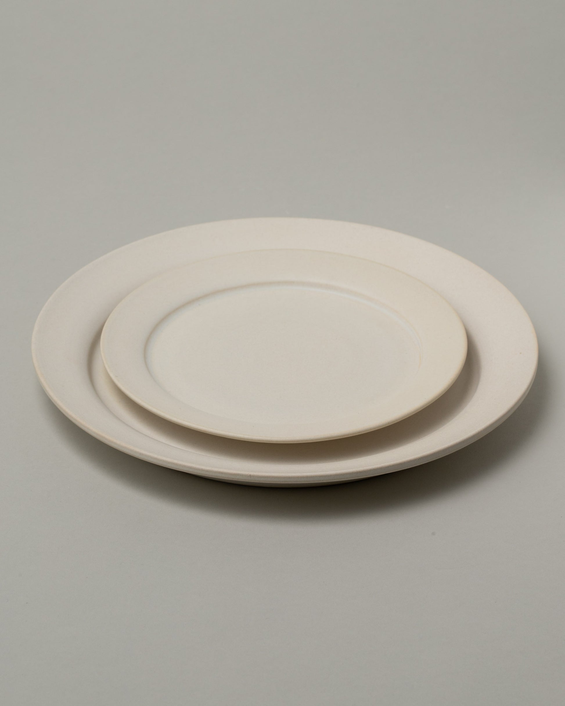 Tracie Hervy Dinner Plate and Salad Plate on light color background.