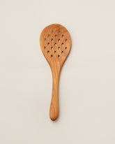 Jonathan's Spoons Skimmer Spoon on light color background.