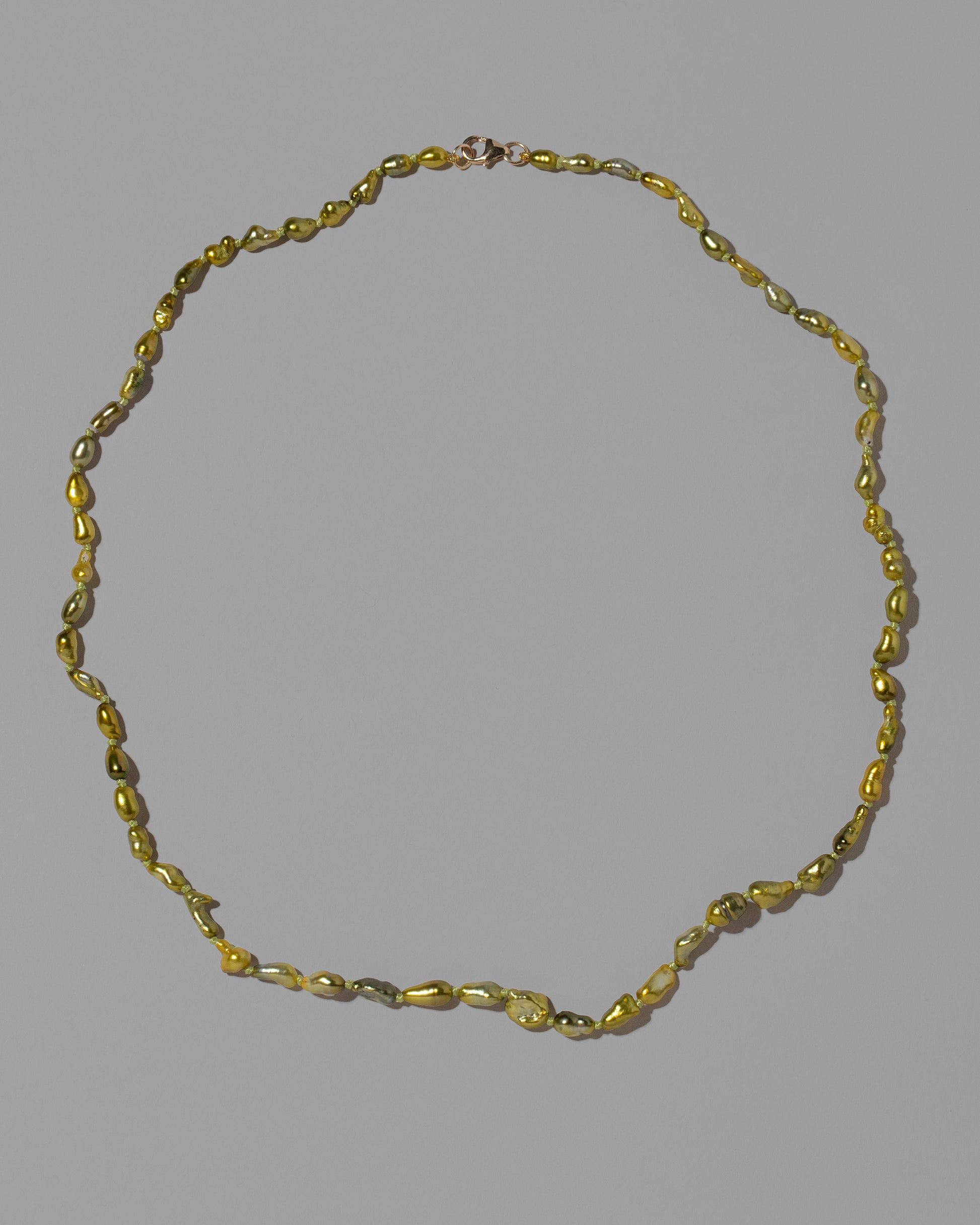 Karkinos Necklace on light color background.
