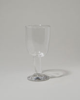 Silje Lindrup Twisted Wine Glass on light color background.